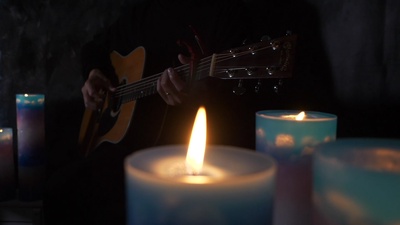 Play a healing guitar surrounded by candles Front Cover